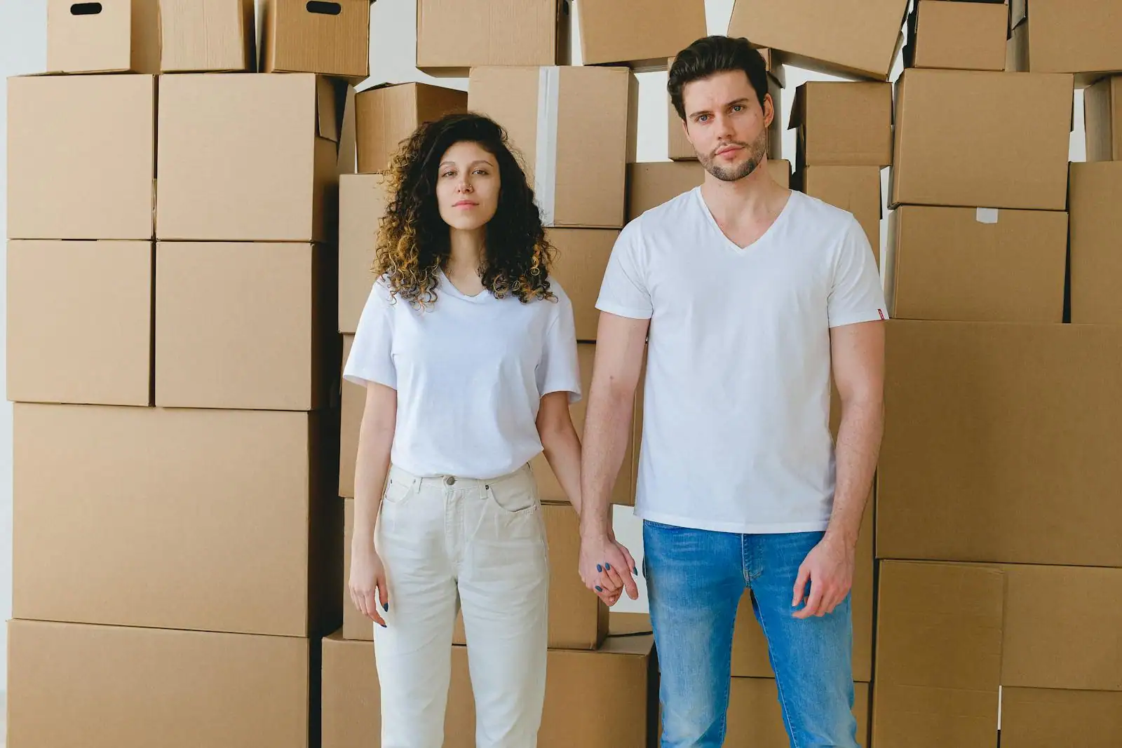 Personne chargeant des cartons de déménagement dans un utilitaire blanc loué