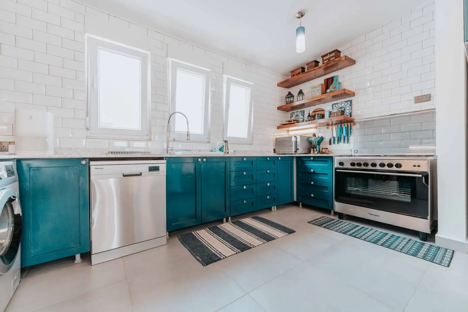 Lave-vaisselle encastré ouvert dans une cuisine moderne, panier chargé de vaisselle